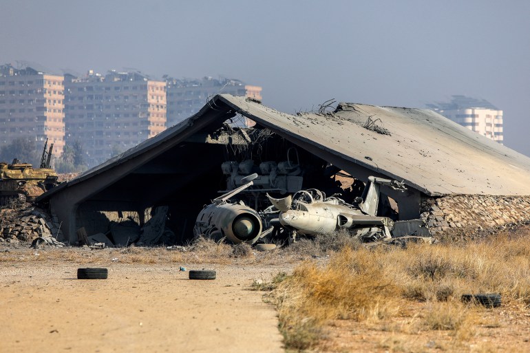 This picture shows a bombed hangar a day after the Israeli military hit weapons depots near the Mazzeh military airport, outside Damascus, on December 9, 2024. - A Syria war monitor said on December 9, that overnight Israeli strikes targeted military positions and depots in several parts of the country, after Islamist-led rebels ousted president Bashar al-Assad. (Photo by Bakr ALKASEM / AFP)