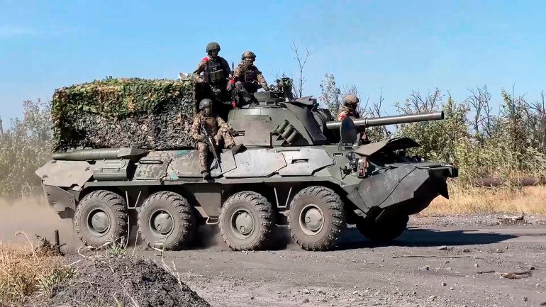 In this photo released by Russian Defense Ministry Press Service on Thursday, Oct. 17, 2024, Russian soldiers ride a self-propelled mortar Nona-SVK at an undisclosed location in Ukraine. (Russian Defense Ministry Press Service via AP)